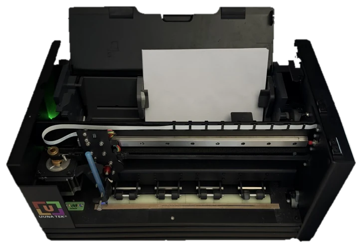 Top view of the handwriting machine with a sheet of paper loaded and a pen carriage over the writing line